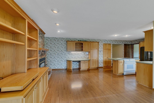 1044 Borgert Ave, Saint Cloud, MN 56303 - kitchen featuring white electric range oven, wallpapered walls, open shelves, freestanding refrigerator, and wood finished floors