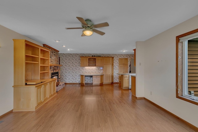 1044 Borgert Ave, Saint Cloud, MN 56303 - unfurnished living room featuring wallpapered walls, ceiling fan, light wood finished floors, and a fireplace