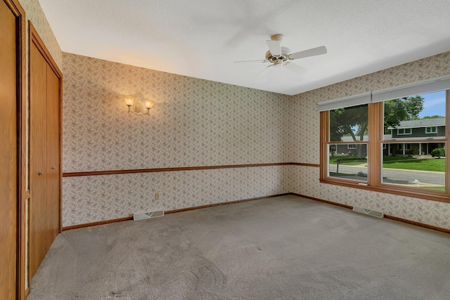 1044 Borgert Ave, Saint Cloud, MN 56303 - empty room featuring carpet flooring, wallpapered walls, and ceiling fan