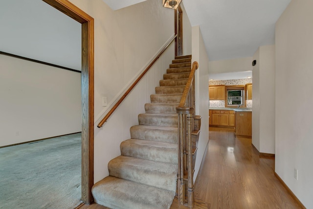 1044 Borgert Ave, Saint Cloud, MN 56303 - staircase featuring wood finished floors and baseboards