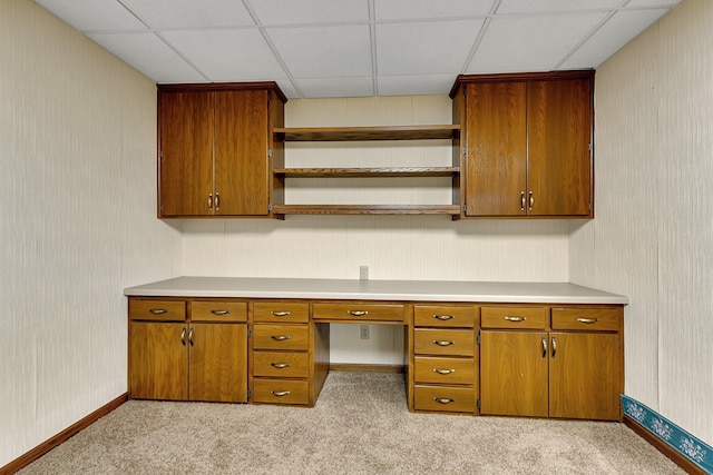 1044 Borgert Ave, Saint Cloud, MN 56303 - unfurnished office featuring wallpapered walls, a paneled ceiling, built in desk, and light colored carpet