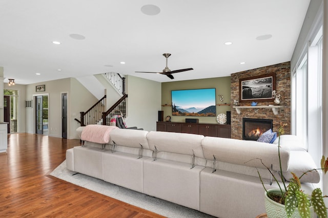 4965 250th St, Elko New Market, MN 55020 - living area featuring wood finished floors, ceiling fan, recessed lighting, a stone fireplace, and stairs