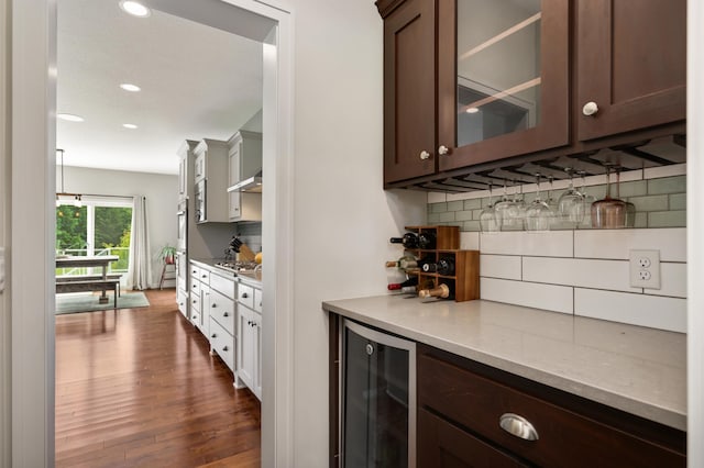 4965 250th St, Elko New Market, MN 55020 - indoor dry bar with wine cooler, decorative backsplash, dark wood-type flooring, stainless steel gas stovetop, and recessed lighting