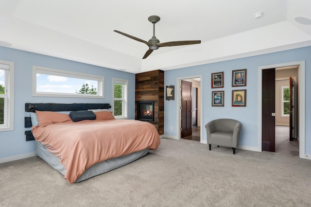 4965 250th St, Elko New Market, MN 55020 - bedroom featuring carpet flooring, a raised ceiling, a ceiling fan, and a fireplace