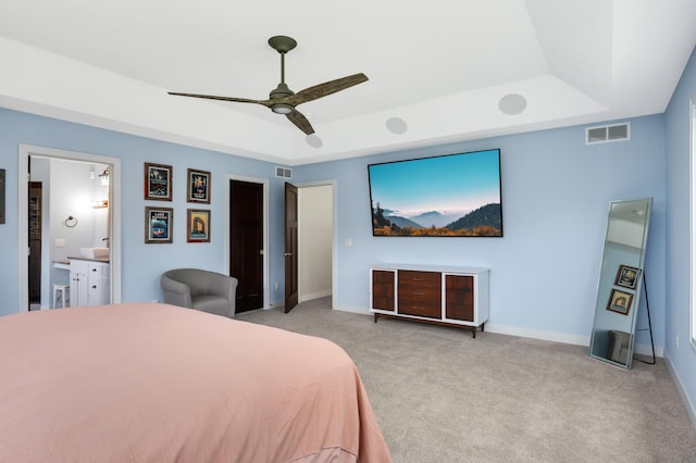 4965 250th St, Elko New Market, MN 55020 - bedroom featuring a raised ceiling, light colored carpet, ceiling fan, and connected bathroom