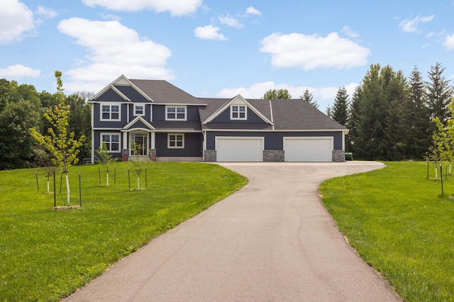 4965 250th St, Elko New Market, MN 55020 - view of front of property featuring asphalt driveway, a front lawn, an attached garage, and stone siding