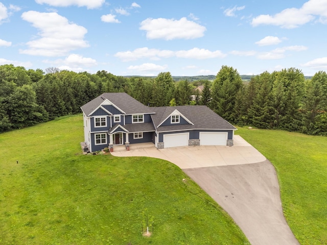 4965 250th St, Elko New Market, MN 55020 - view of front of home featuring driveway, a front yard, stone siding, and a wooded view