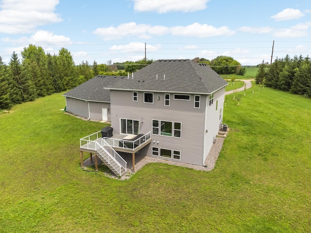 4965 250th St, Elko New Market, MN 55020 - rear view of house featuring a deck, a shingled roof, a lawn, and stairs
