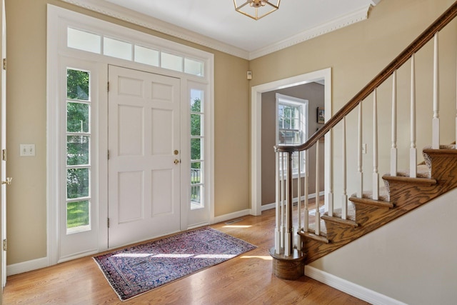 10636 Purdey Rd, Eden Prairie, MN 55347 - entryway featuring light wood finished floors, stairs, and ornamental molding