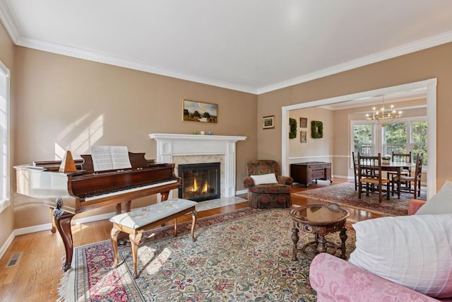 10636 Purdey Rd, Eden Prairie, MN 55347 - living area with wood finished floors, a chandelier, ornamental molding, and a high end fireplace