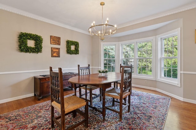 10636 Purdey Rd, Eden Prairie, MN 55347 - dining space with a chandelier, plenty of natural light, wood finished floors, and crown molding