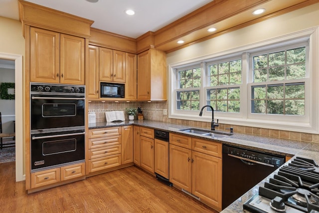 10636 Purdey Rd, Eden Prairie, MN 55347 - kitchen featuring black appliances, light wood finished floors, ornamental molding, tasteful backsplash, and dark stone counters