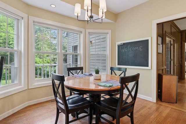 10636 Purdey Rd, Eden Prairie, MN 55347 - dining space with light wood finished floors and a chandelier