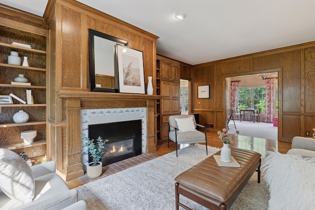 10636 Purdey Rd, Eden Prairie, MN 55347 - living room with built in shelves, a tiled fireplace, and wooden walls