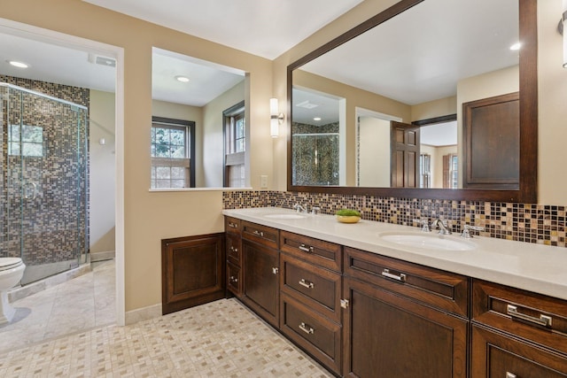 10636 Purdey Rd, Eden Prairie, MN 55347 - bathroom featuring a shower stall, double vanity, and tasteful backsplash