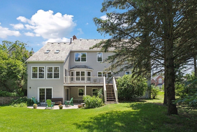 10636 Purdey Rd, Eden Prairie, MN 55347 - rear view of house with stairs, a patio, a wooden deck, and a lawn