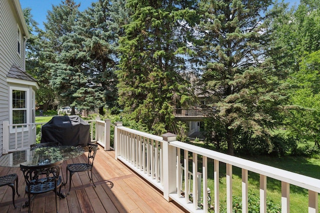 10636 Purdey Rd, Eden Prairie, MN 55347 - wooden deck featuring view of wooded area, grilling area, and outdoor dining area
