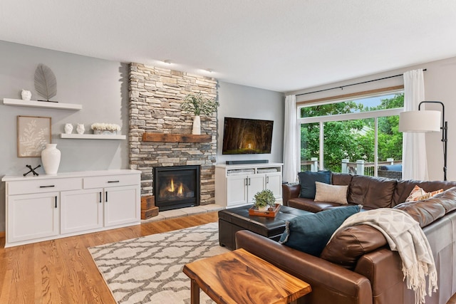 2061 Langston Ln NE, Saint Michael, MN 55376 - living area with light wood-type flooring and a stone fireplace