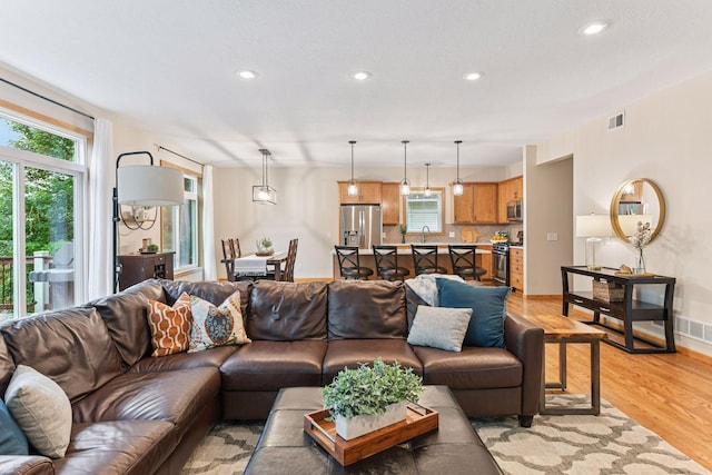 2061 Langston Ln NE, Saint Michael, MN 55376 - living area featuring light wood-style flooring, healthy amount of natural light, and recessed lighting