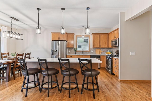 2061 Langston Ln NE, Saint Michael, MN 55376 - kitchen featuring appliances with stainless steel finishes, decorative backsplash, light wood-style flooring, and light countertops