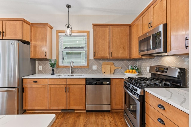 2061 Langston Ln NE, Saint Michael, MN 55376 - kitchen featuring appliances with stainless steel finishes, dark wood-style floors, tasteful backsplash, and brown cabinets