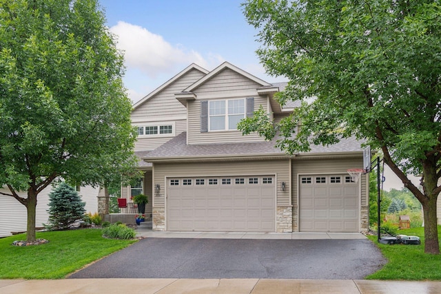 2061 Langston Ln NE, Saint Michael, MN 55376 - view of front of home with stone siding, driveway, an attached garage, a front yard, and roof with shingles