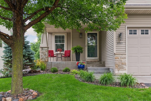 2061 Langston Ln NE, Saint Michael, MN 55376 - entrance to property with a porch, a lawn, a garage, and stone siding