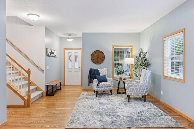 2061 Langston Ln NE, Saint Michael, MN 55376 - sitting room with light wood finished floors and stairs