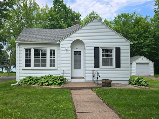 201 Polk Ave S, Frederic, WI 54837 - bungalow-style home with an outdoor structure, a front lawn, a chimney, and a garage