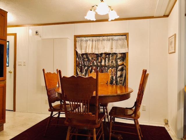 45568 213th Ln, Aitkin, MN 56431 - dining area featuring a chandelier and crown molding