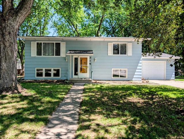 314 11th St, Montevideo, MN 56265 - bi-level home with a garage, a front yard, and concrete driveway