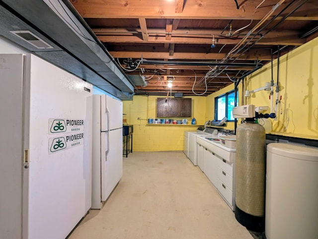 314 11th St, Montevideo, MN 56265 - below grade area featuring freestanding refrigerator, a water softener, and separate washer and dryer