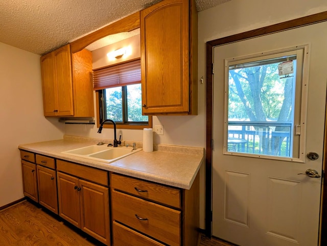314 11th St, Montevideo, MN 56265 - kitchen with a textured ceiling, light countertops, and dark wood-style floors