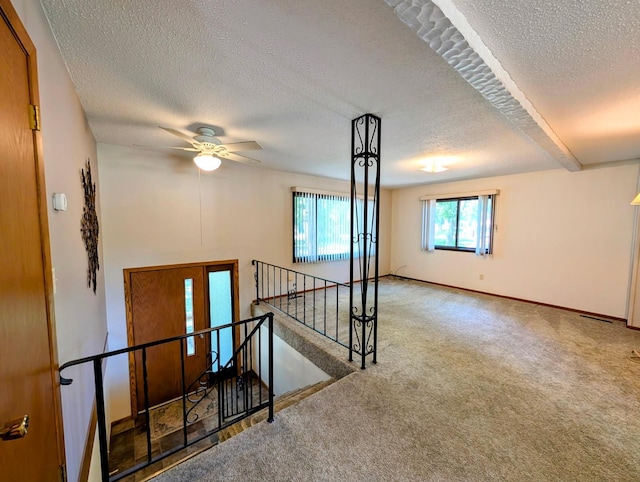 314 11th St, Montevideo, MN 56265 - empty room featuring a textured ceiling, carpet, and a ceiling fan