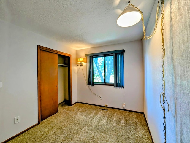 314 11th St, Montevideo, MN 56265 - unfurnished bedroom featuring a textured ceiling, carpet floors, and a closet