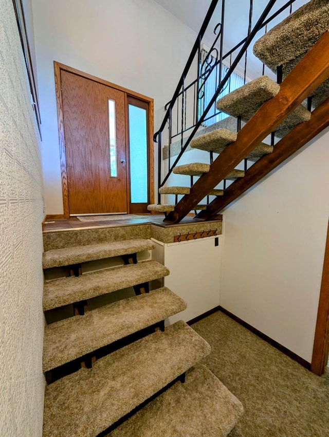 314 11th St, Montevideo, MN 56265 - stairway featuring baseboards and carpet flooring