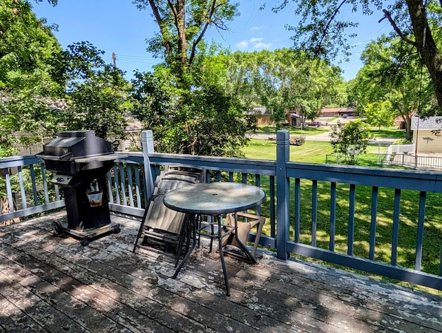 314 11th St, Montevideo, MN 56265 - wooden deck featuring area for grilling and a lawn