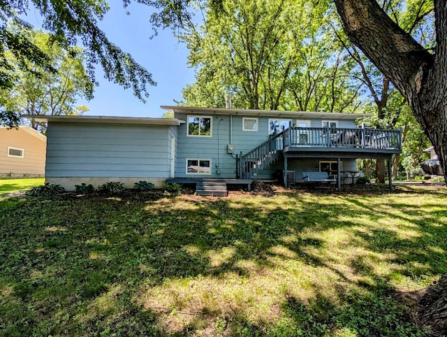 314 11th St, Montevideo, MN 56265 - rear view of property featuring a wooden deck, stairway, and a lawn