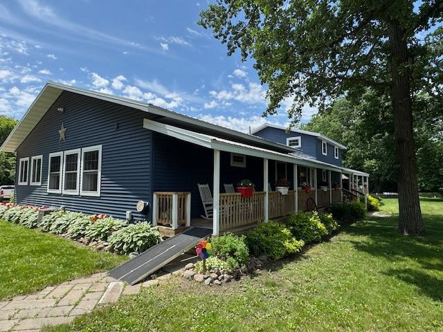 14717 State 210, Stowe Prairie Twp, MN 56453 - rear view of property with covered porch and a lawn