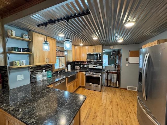 14717 State 210, Stowe Prairie Twp, MN 56453 - kitchen with appliances with stainless steel finishes, open shelves, a peninsula, and plenty of natural light