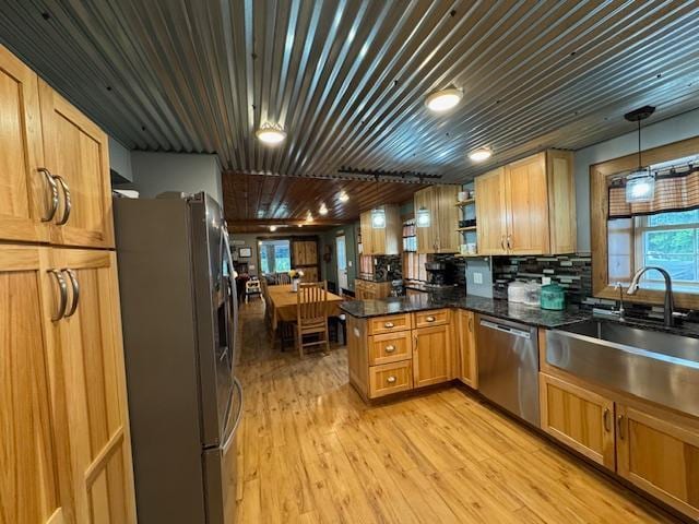 14717 State 210, Stowe Prairie Twp, MN 56453 - kitchen with stainless steel appliances, a peninsula, open shelves, light wood-type flooring, and hanging light fixtures