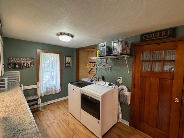 14717 State 210, Stowe Prairie Twp, MN 56453 - laundry area featuring independent washer and dryer, light wood finished floors, and a textured ceiling