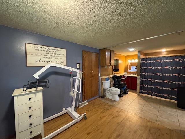 14717 State 210, Stowe Prairie Twp, MN 56453 - workout area with light wood-type flooring and a textured ceiling