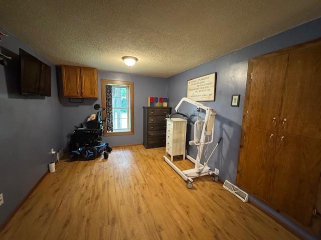 14717 State 210, Stowe Prairie Twp, MN 56453 - workout area with light wood-style flooring and a textured ceiling