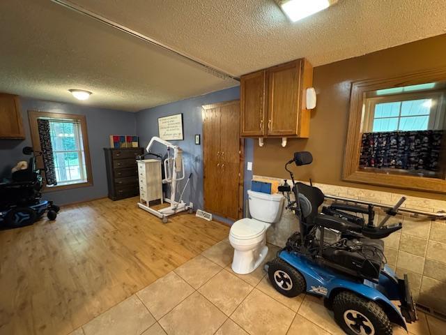 14717 State 210, Stowe Prairie Twp, MN 56453 - exercise room with a textured ceiling