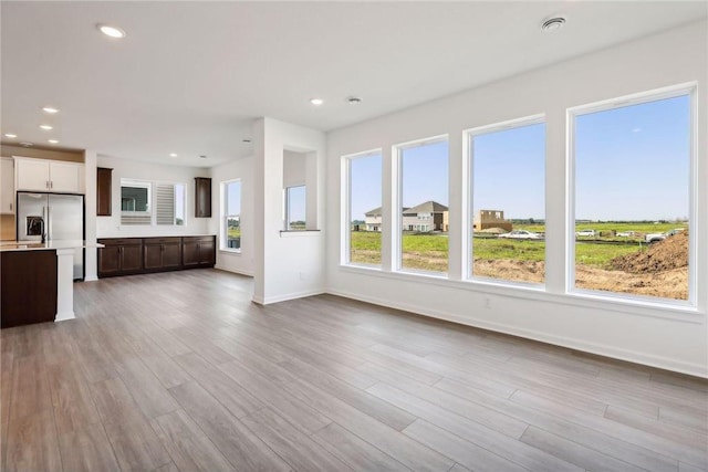 unfurnished living room featuring wood finished floors and recessed lighting