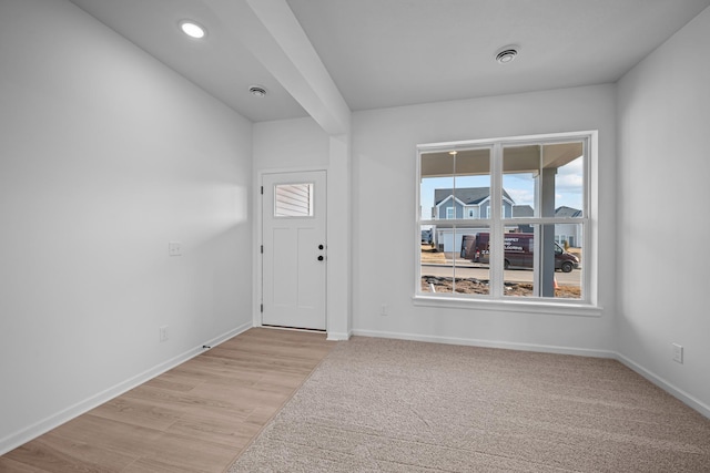 entrance foyer with light wood finished floors and recessed lighting