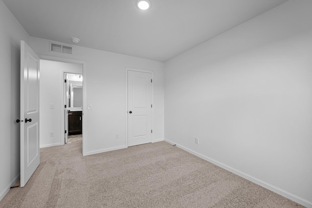 unfurnished bedroom featuring light carpet and recessed lighting