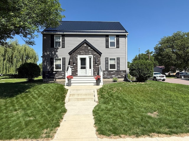 411 Vernon Ave, Morgan, MN 56266 - view of front of house with a front lawn, stone siding, and a metal roof