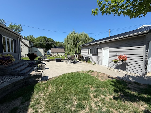 411 Vernon Ave, Morgan, MN 56266 - view of grassy yard with a patio and an outdoor fire pit